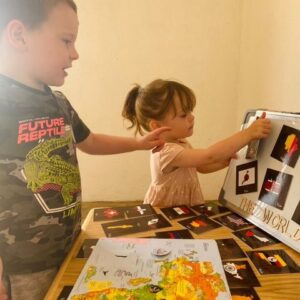 Brother and sister learning about countries and flags of the world